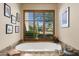 Relaxing bathroom with a free-standing tub and a view from a large window at 19481 N 98Th Pl, Scottsdale, AZ 85255