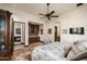 Comfortable bedroom with a king bed, built in cabinetry, and a private sitting area at 19481 N 98Th Pl, Scottsdale, AZ 85255