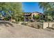 Luxury home exterior with a brick driveway at 19481 N 98Th Pl, Scottsdale, AZ 85255