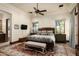 Bright bedroom with a king-size bed, ceiling fan, and ample closet space at 19481 N 98Th Pl, Scottsdale, AZ 85255