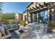 Back patio with fire pit and seating area, adjacent to a beautiful home at 19481 N 98Th Pl, Scottsdale, AZ 85255