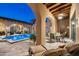 Relaxing outdoor patio with arches and views of the pool at 19481 N 98Th Pl, Scottsdale, AZ 85255