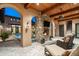 Spacious patio features a fireplace, comfortable seating, and views of the pool at 19481 N 98Th Pl, Scottsdale, AZ 85255