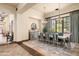 Bright dining room with a large table, beautiful chandelier, and hardwood floors at 19481 N 98Th Pl, Scottsdale, AZ 85255