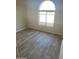 Bright bedroom with an arched window and tile flooring at 7127 W Vogel Ave, Peoria, AZ 85345