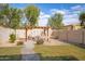 Landscaped backyard with pergola, patio, and pathway at 2510 E Fawn Dr, Phoenix, AZ 85042