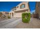 Two-story house with tan exterior, arched entryway, and a two-car garage at 2510 E Fawn Dr, Phoenix, AZ 85042