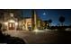 Luxury home exterior with a large driveway at night at 4836 E White Gates Dr, Phoenix, AZ 85018