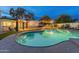 Relaxing kidney-shaped pool with surrounding patio and lighting at 5632 E Emile Zola Ave, Scottsdale, AZ 85254