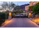 Elegant gated entry with brick pavers and landscape lighting at 4836 E White Gates Dr, Phoenix, AZ 85018