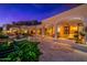 Outdoor patio area with pool and mountain views at night at 4836 E White Gates Dr, Phoenix, AZ 85018