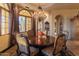 Formal dining room with ornate chandelier, hardwood floors and large windows at 4836 E White Gates Dr, Phoenix, AZ 85018