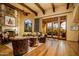 Spacious living room with hardwood floors, stone fireplace, and access to a patio at 4836 E White Gates Dr, Phoenix, AZ 85018