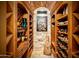 Impressive wine cellar with brick ceiling, stone walls, and ample storage at 4836 E White Gates Dr, Phoenix, AZ 85018