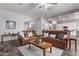Spacious living room with two brown leather sofas and a large coffee table at 23680 N 168Th Ln, Surprise, AZ 85387