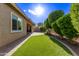Landscaped backyard with artificial turf and brick patio at 23680 N 168Th Ln, Surprise, AZ 85387