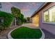 Landscaped backyard with a grassy area and patio at 23680 N 168Th Ln, Surprise, AZ 85387
