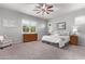 Bright bedroom featuring a plush bed, window shutters, and wood dresser at 23680 N 168Th Ln, Surprise, AZ 85387