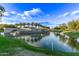 Community entrance with lake and palm trees at 23680 N 168Th Ln, Surprise, AZ 85387