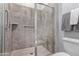 Large walk-in shower with neutral tile and glass door at 23680 N 168Th Ln, Surprise, AZ 85387