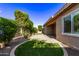 Landscaped backyard with artificial turf and brick patio at 23680 N 168Th Ln, Surprise, AZ 85387