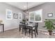 Elegant dining room with a granite-top table, chandelier, and plant accents at 23680 N 168Th Ln, Surprise, AZ 85387