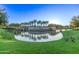 Attractive community entrance with a lake and landscaping at 23680 N 168Th Ln, Surprise, AZ 85387