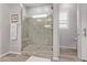 Elegant bathroom with a large walk-in shower and tiled flooring at 23680 N 168Th Ln, Surprise, AZ 85387