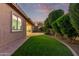 Landscaped backyard with a grassy area and patio at 23680 N 168Th Ln, Surprise, AZ 85387