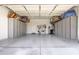 Spacious garage with overhead storage and built-in cabinets at 23680 N 168Th Ln, Surprise, AZ 85387