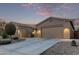 Single story home with a two car garage and desert landscaping at 23680 N 168Th Ln, Surprise, AZ 85387