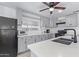 Gray kitchen cabinets with quartz countertops and a black microwave at 2650 W Union Hills Dr # 258, Phoenix, AZ 85027