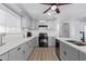 Modern kitchen with gray cabinets, quartz countertops, and black appliances at 2650 W Union Hills Dr # 258, Phoenix, AZ 85027