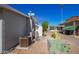 Side yard view of mobile home with gravel and cacti at 2650 W Union Hills Dr # 258, Phoenix, AZ 85027