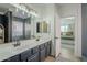 Bathroom with dual vanities, a view into a bedroom, and a walk-in shower at 4349 E Smokehouse E Trl, Cave Creek, AZ 85331