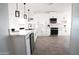 Modern white kitchen with stainless steel appliances and island at 37179 W Illini St, Tonopah, AZ 85354