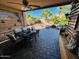 Covered patio with outdoor dining set and view of backyard at 15428 W Mauna Loa Ln, Surprise, AZ 85379