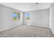 Bright bedroom with neutral walls, carpet flooring, and two windows at 5616 W Paseo Way, Laveen, AZ 85339