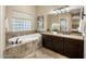 Luxurious bathroom with soaking tub and granite countertops at 28847 N Royce Rd, San Tan Valley, AZ 85144