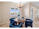 Charming breakfast nook with round table and blue chairs at 28847 N Royce Rd, San Tan Valley, AZ 85144