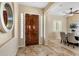 Elegant entryway with rich wood door and tile flooring at 28847 N Royce Rd, San Tan Valley, AZ 85144