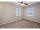 Bedroom with two windows, ceiling fan, and carpet at 28847 N Royce Rd, San Tan Valley, AZ 85144