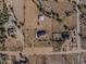Aerial view of a property with multiple buildings, a pool, and expansive land at 28847 N Royce Rd, San Tan Valley, AZ 85144