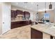 Spacious kitchen with dark wood cabinets and granite countertops at 28847 N Royce Rd, San Tan Valley, AZ 85144