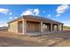 Single-story house with tan siding, tile roof, and covered patio at 28847 N Royce Rd, San Tan Valley, AZ 85144