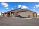 View of the house's side, revealing a three-car garage and covered patio at 28847 N Royce Rd, San Tan Valley, AZ 85144