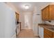 Kitchen with wood cabinets, white appliances, and tile floor at 3270 S Goldfield Rd # 315, Apache Junction, AZ 85119