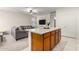 Kitchen island with seating, wood cabinets and stainless steel appliances at 21561 W Kimberly Dr, Buckeye, AZ 85326