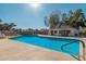 Community pool with surrounding lounge chairs and patio area at 1116 E Belmont Ave, Phoenix, AZ 85020