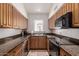 Small kitchen with granite countertops and wood cabinets at 1116 E Belmont Ave, Phoenix, AZ 85020